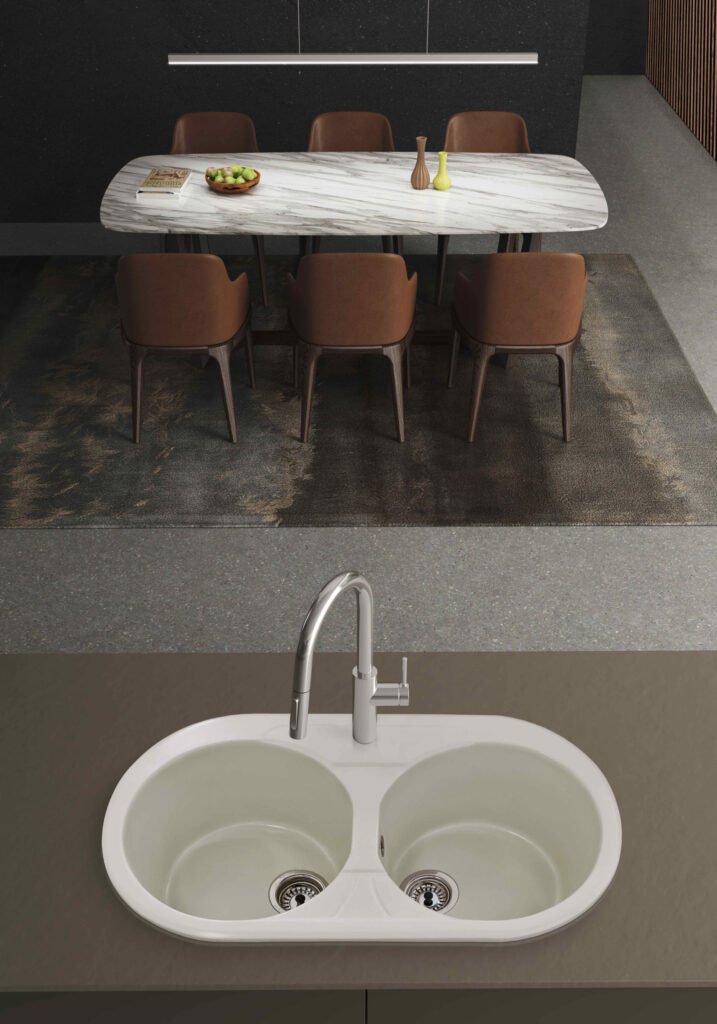 Fregadero Delfos de dos senos circulares instalado sobre encimera; grifería, encimera, mueble y decoración no incluidos.